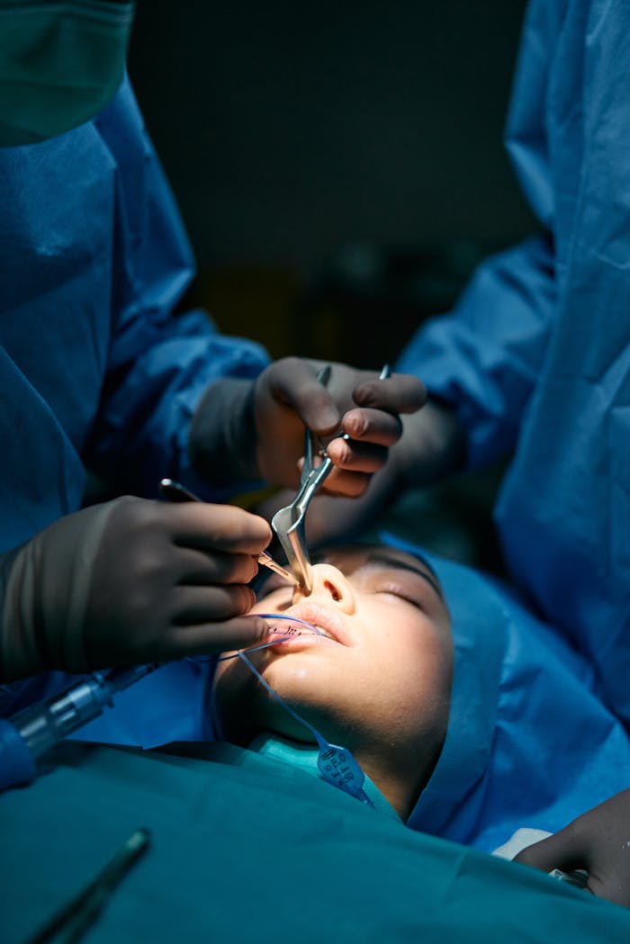 Close-up of Woman being Operated by Two Surgeons